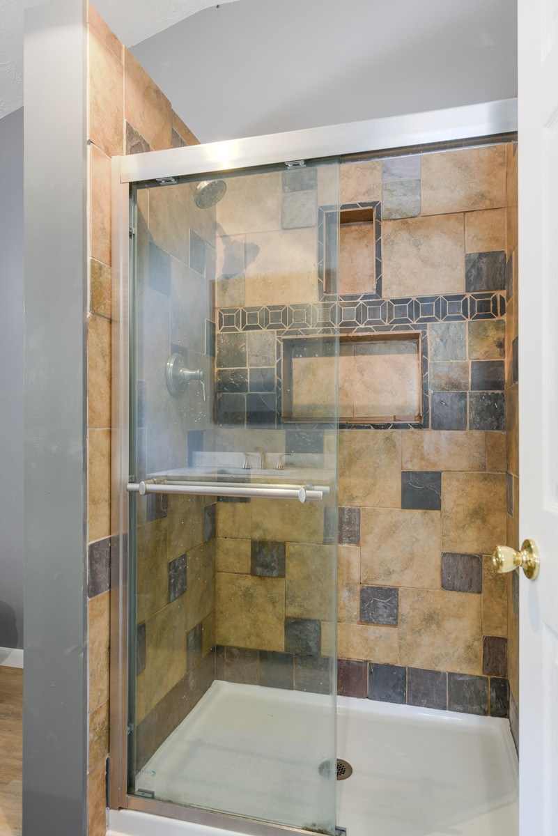 1840 Garrison Branch Road Cottontown, TN 37048 - Photo 19 of 41 Walk-in shower features sliding glass doores and oversized tile.