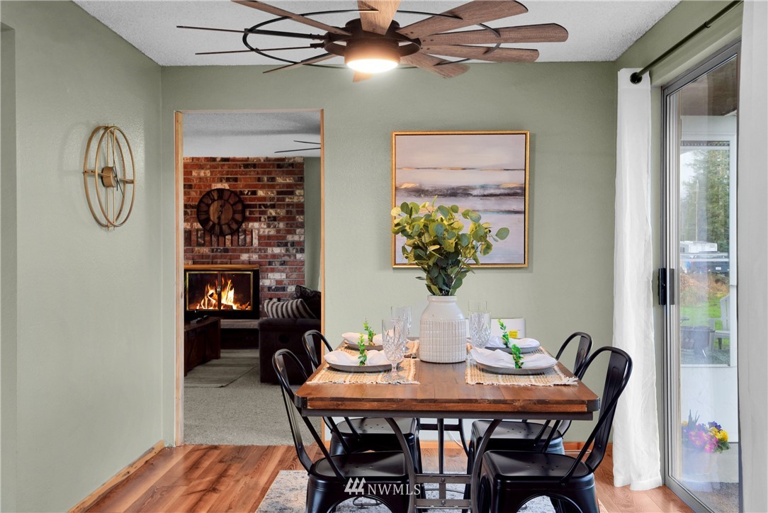 35704 Reese Road Sultan, WA 98294 - Photo 8 of 35 a dining room with furniture a chandelier and wooden floor