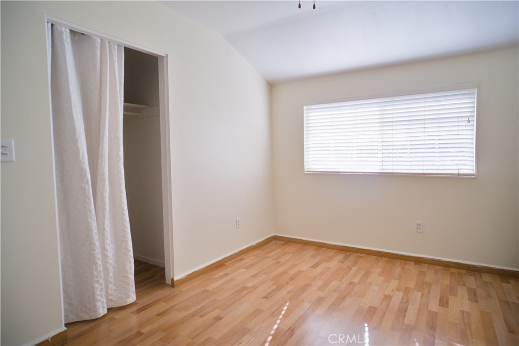 1312 Durham Street Simi Valley, CA 93065 - Photo 6 of 10 an empty room with wooden floor and a window