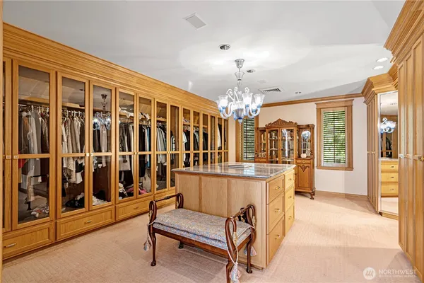 a bedroom with a bed and large windows