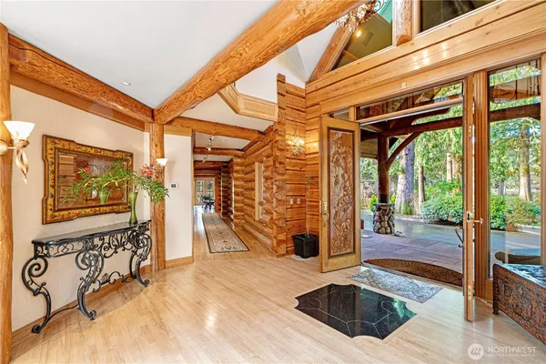 a living room with furniture a fireplace and a floor to ceiling window
