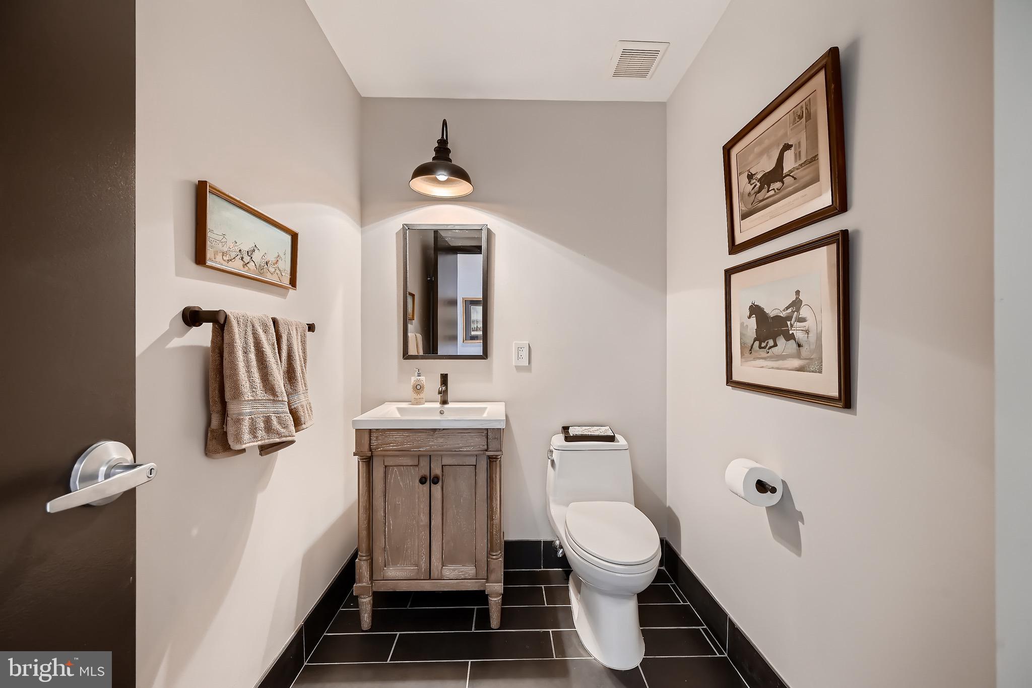 1200 Steuart Street, Unit 1611 Baltimore, MD 21230 - Photo 18 of 34 a bathroom with a toilet a sink and mirror