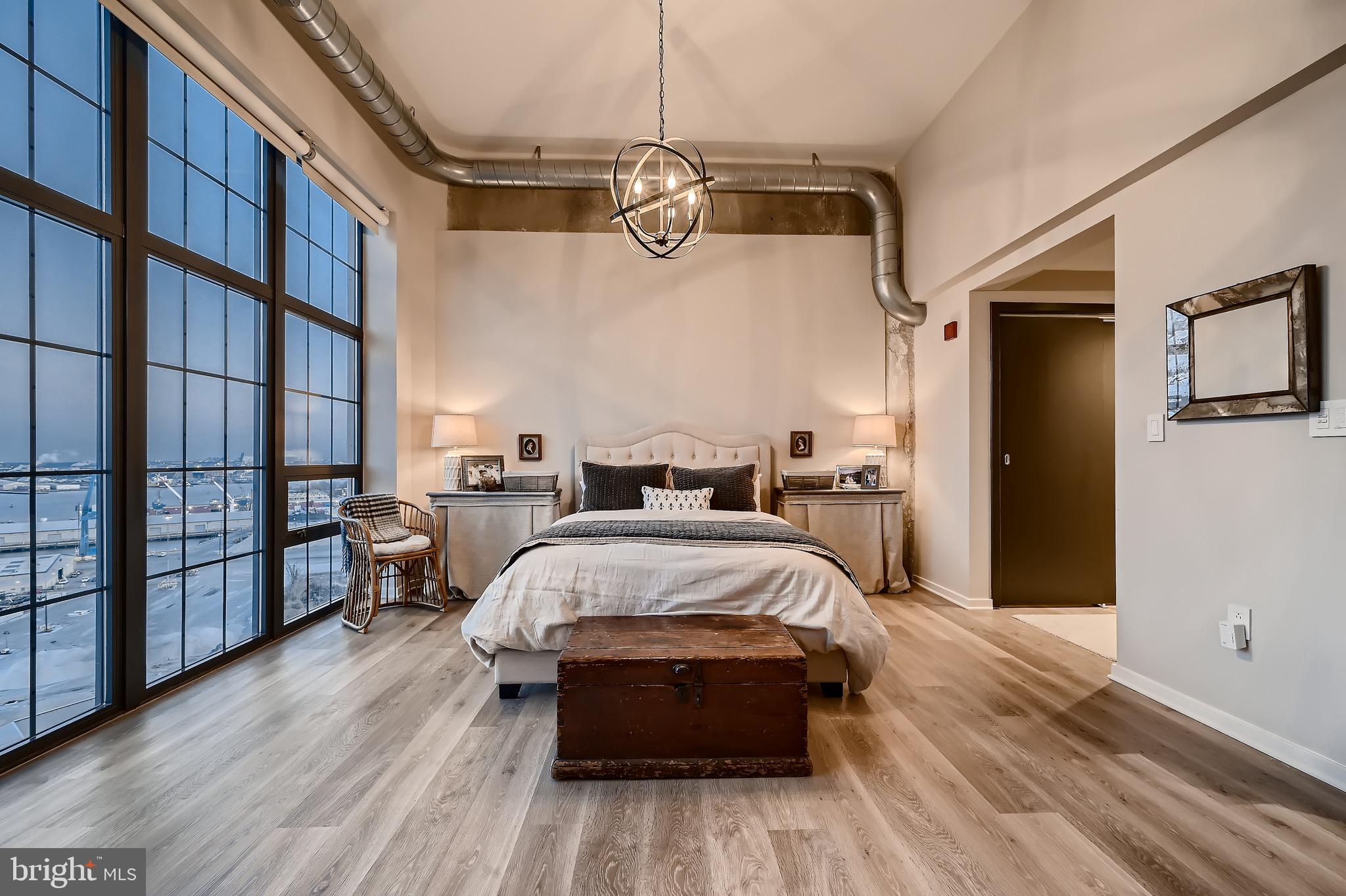 1200 Steuart Street, Unit 1611 Baltimore, MD 21230 - Photo 22 of 34 a spacious bedroom with a bed and a window