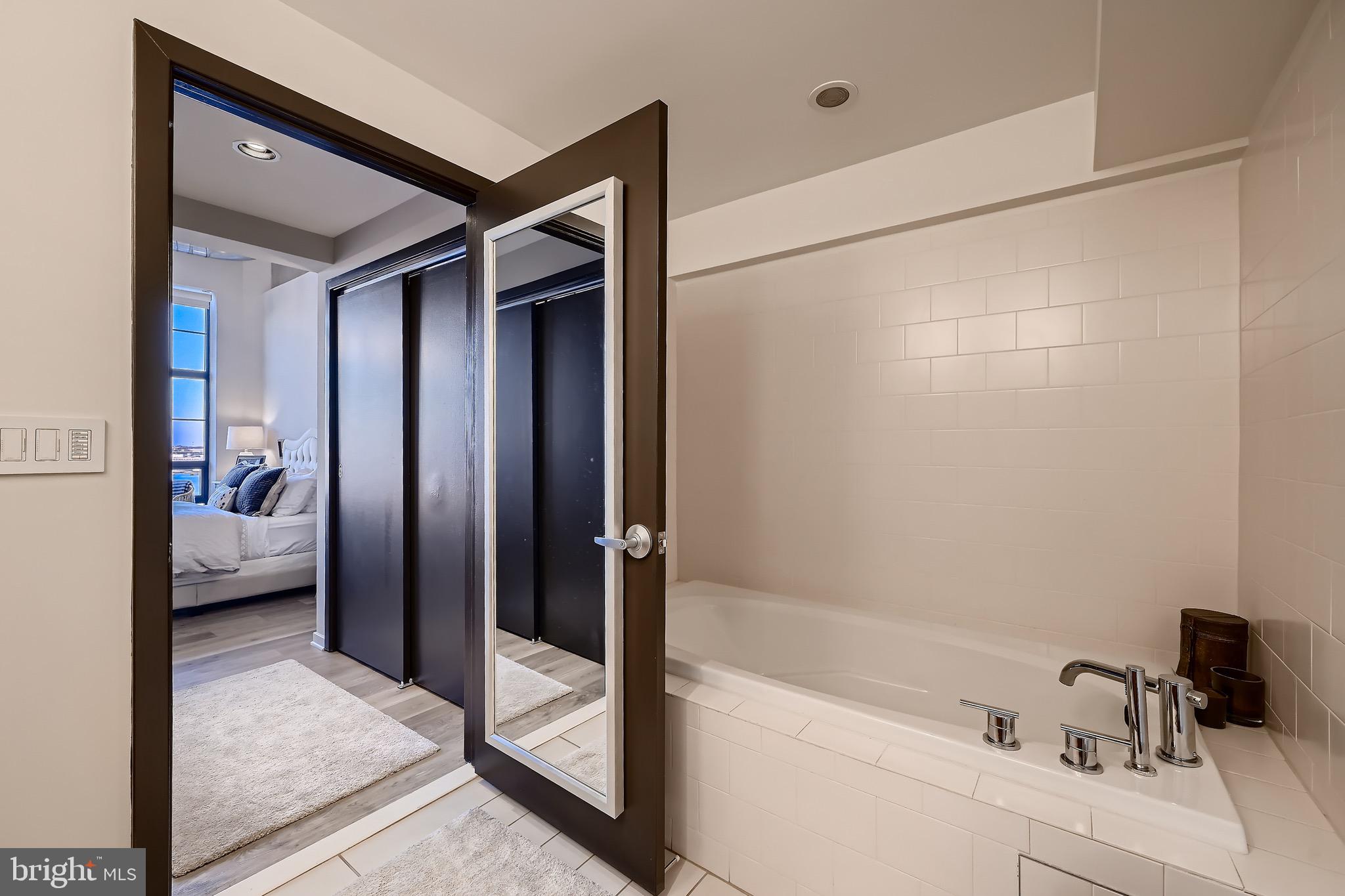 1200 Steuart Street, Unit 1611 Baltimore, MD 21230 - Photo 24 of 34 a bathroom with a tub and shower