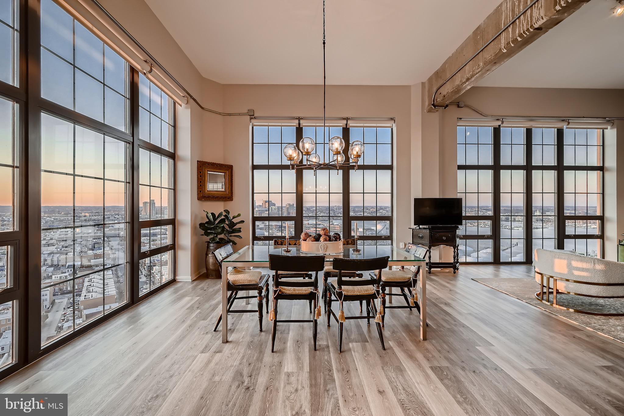 1200 Steuart Street, Unit 1611 Baltimore, MD 21230 - Photo 7 of 34 a view of a dining room with furniture window and wooden floor