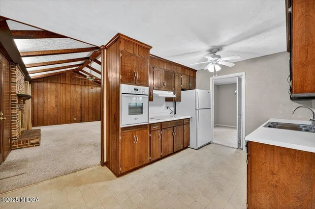 a spacious bathroom with a granite countertop sink a mirror and shower