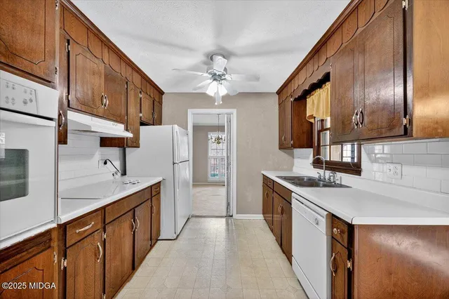 a kitchen with stainless steel appliances granite countertop a sink and cabinets