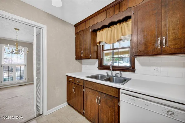 a kitchen with a sink window and cabinets