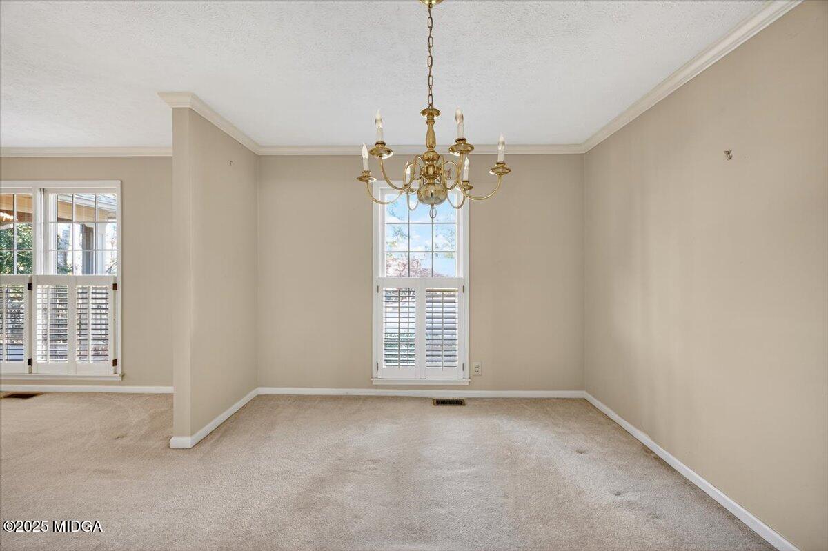 673 Commanche Drive Macon, GA 31210 - Photo 16 of 40 a view of a big room with windows and chandelier