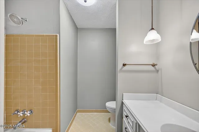 a bathroom with a toilet a sink and shower