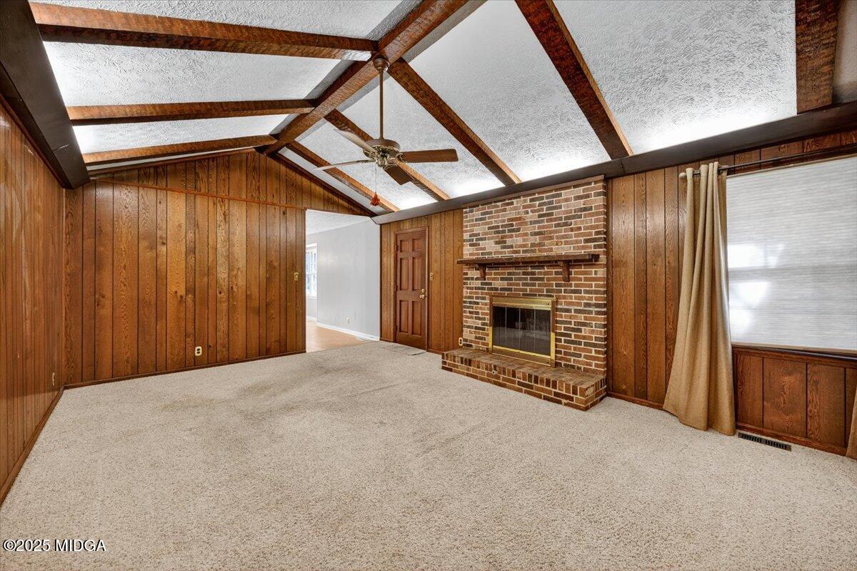 673 Commanche Drive Macon, GA 31210 - Photo 9 of 40 a view of an empty room with a fireplace and windows