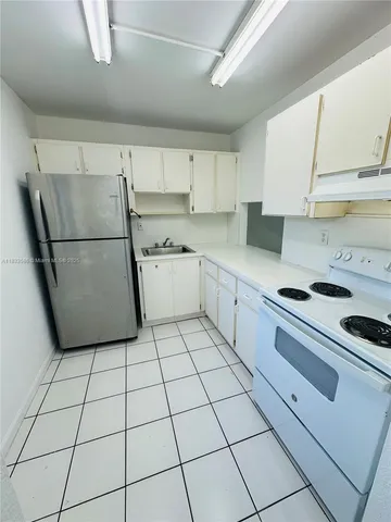 a kitchen with cabinets and white appliances