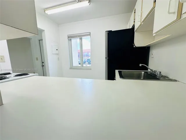 a bedroom with a bed and a large mirror