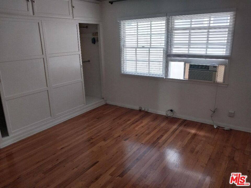 8559 Holloway Drive, Unit 2 West Hollywood, CA 90069 - Photo 3 of 10 a view of empty room with wooden floor and fan