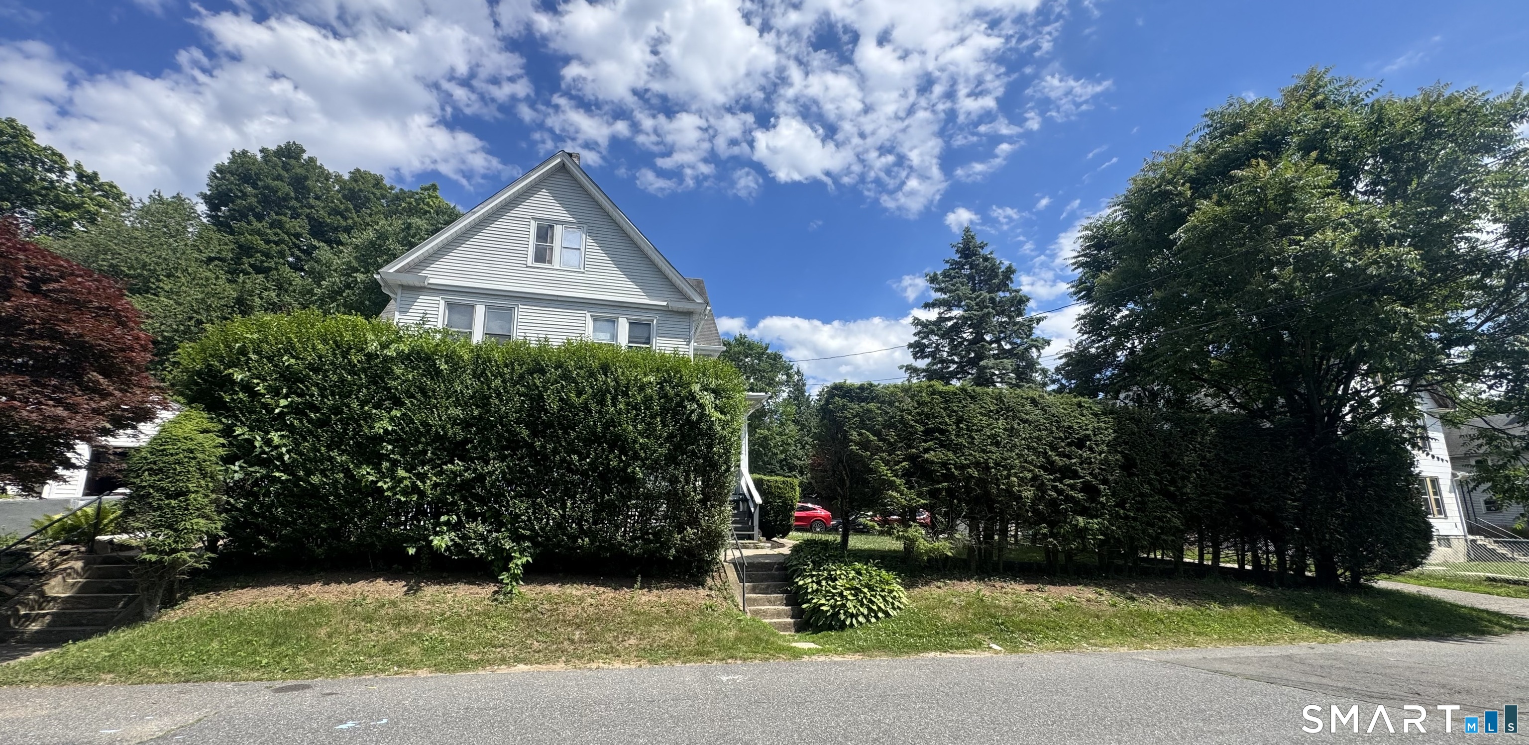 104 Prospect Street Ansonia, CT 06401 - Photo 2 of 40 a front view of a house with a yard and garage