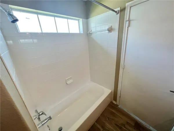 a bathroom with a bathtub and a shower