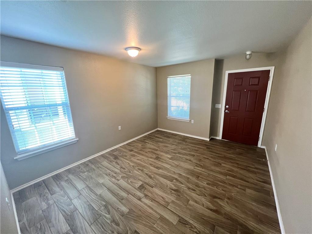 7813 Duber Lane Austin, TX 78747 - Photo 18 of 20 a view of an empty room with wooden floor and a window
