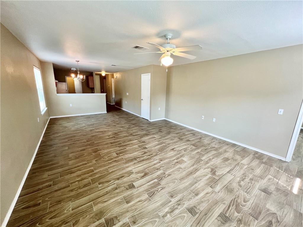 7813 Duber Lane Austin, TX 78747 - Photo 8 of 20 a view of a livingroom with wooden floor and a ceiling fan