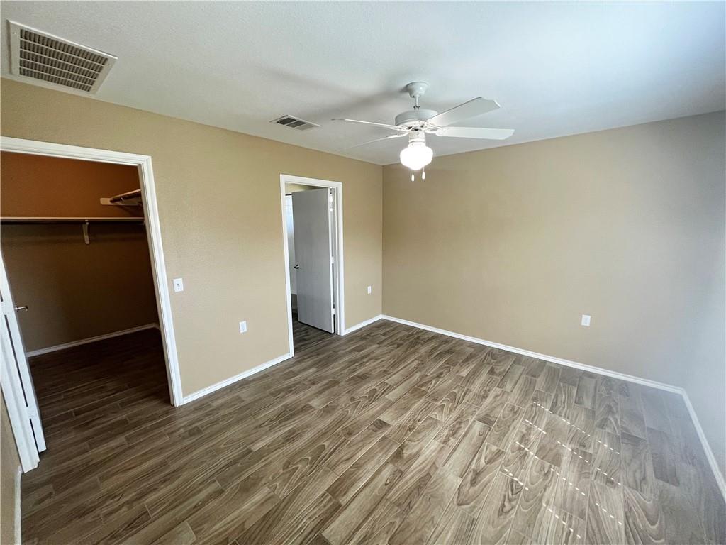 7813 Duber Lane Austin, TX 78747 - Photo 10 of 20 wooden floor in an empty room with a window