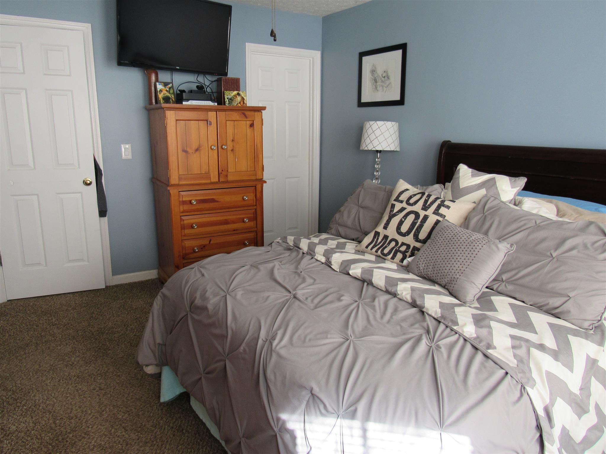 307 Butler Road Portland, TN 37148 - Photo 17 of 21 a bedroom with a bed and painting on the wall