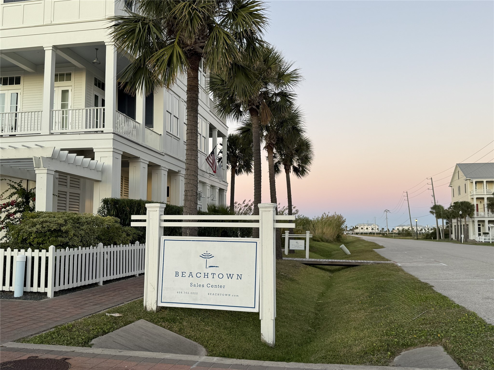 a view of a house with a yard and potted plants