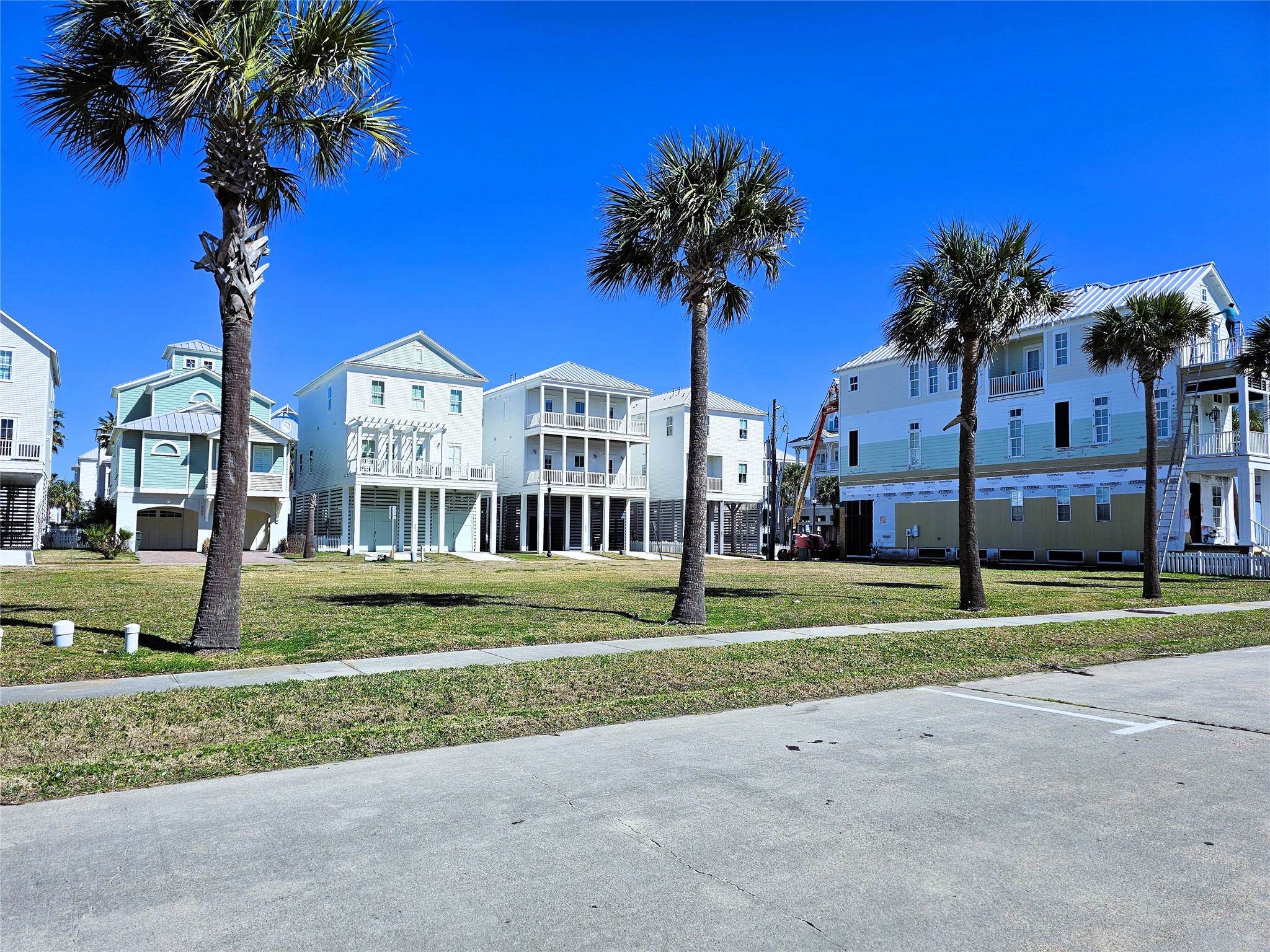 722-726 Ramsar Road Galveston, TX 77550 - Photo 4 of 9 a view of a house with a yard and palm trees