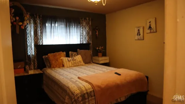 a bed sitting in a bedroom next to a window