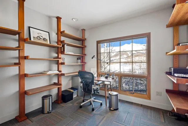 a view of a hallway with wooden floor and doors