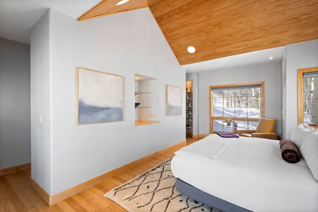 a bedroom with a large bed and a large window