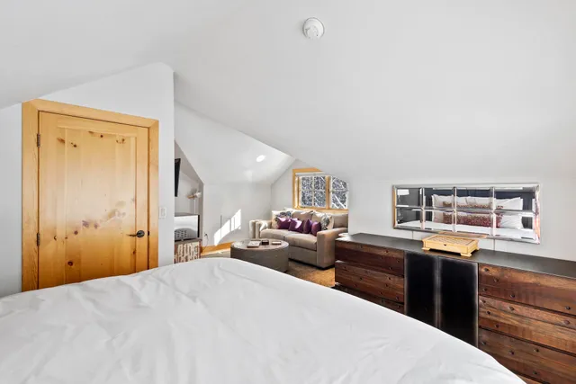 a large bed sitting in a bedroom next to a window