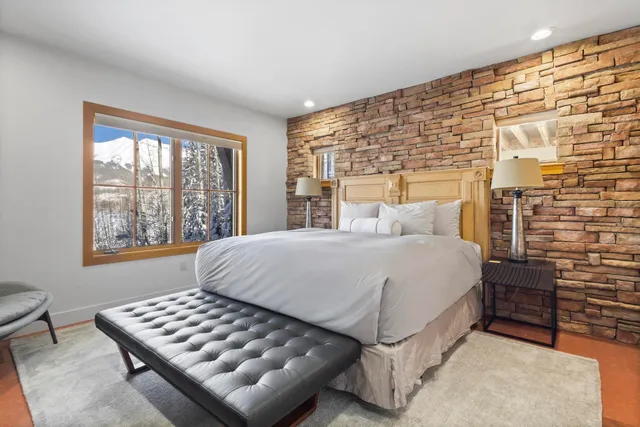a living room with granite countertop furniture and a wooden floor