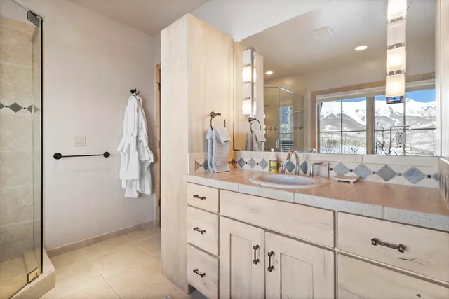a bath tub sitting next to a bathroom sink and a shower