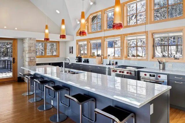 a large kitchen with stainless steel appliances lots of counter space and breakfast area