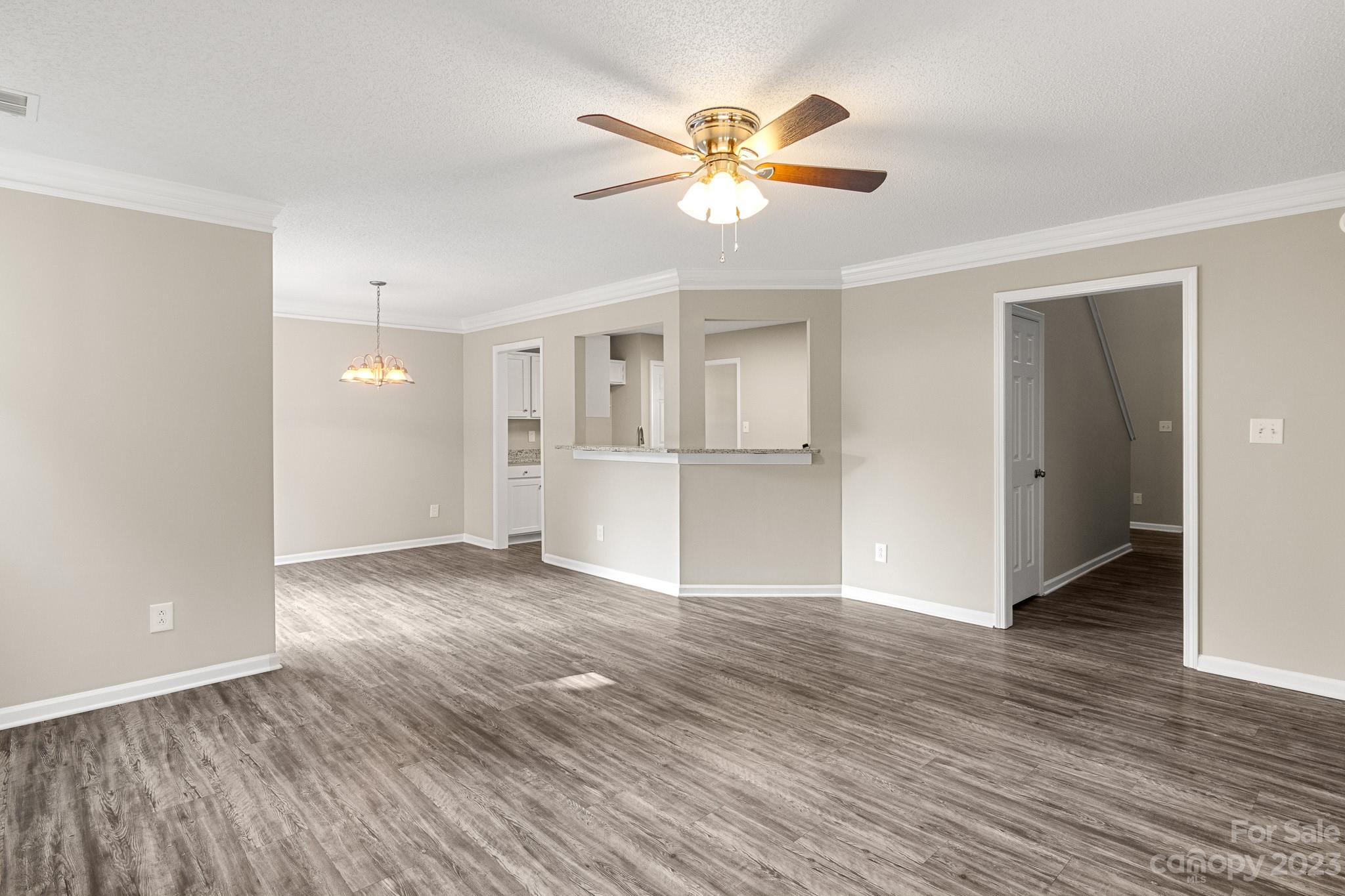 845 Raindrops Road Gastonia, NC 28054 - Photo 14 of 40 a view of an empty room with wooden floor and a ceiling fan