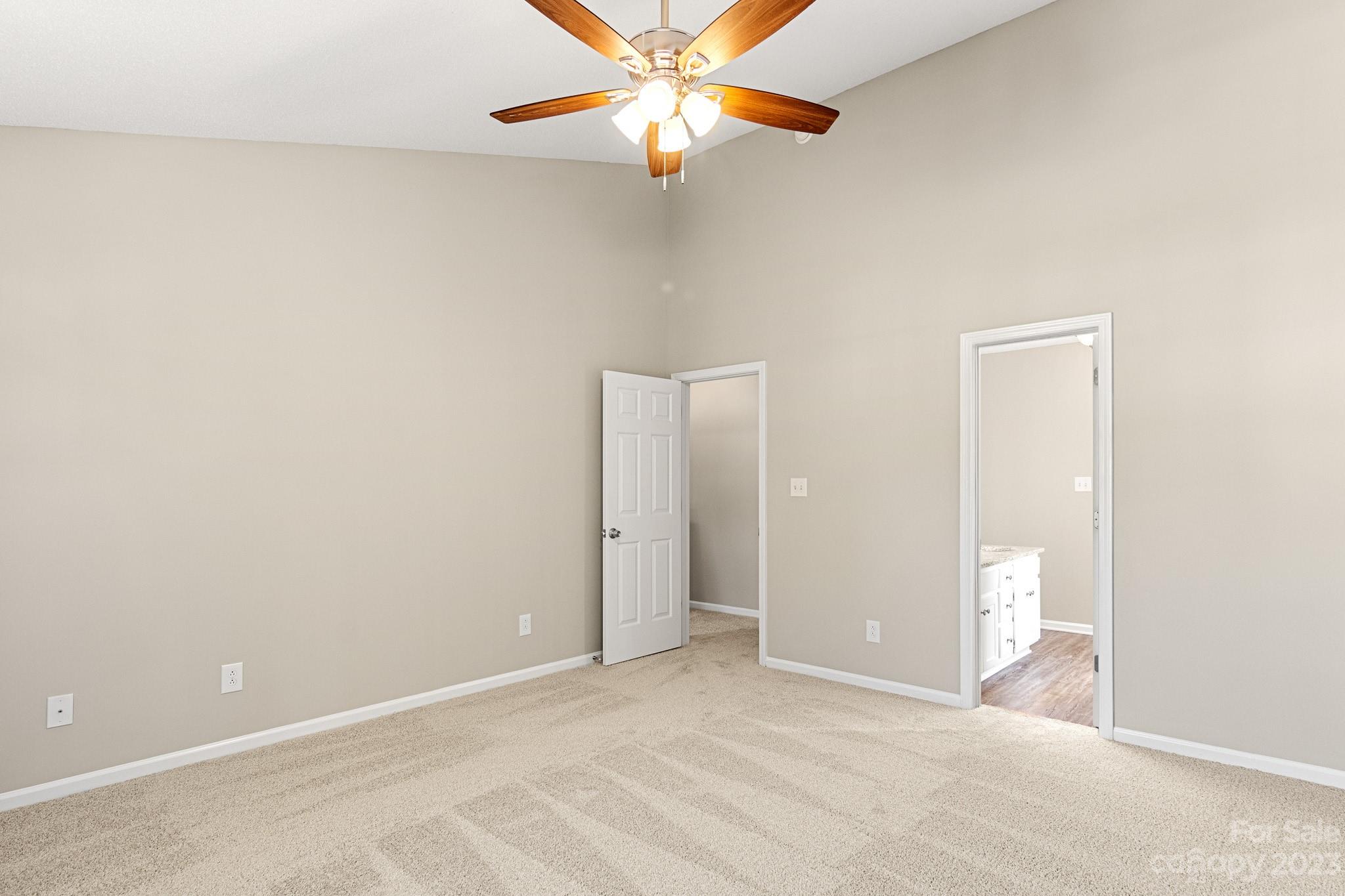845 Raindrops Road Gastonia, NC 28054 - Photo 24 of 40 an empty room with closet and a chandelier fan