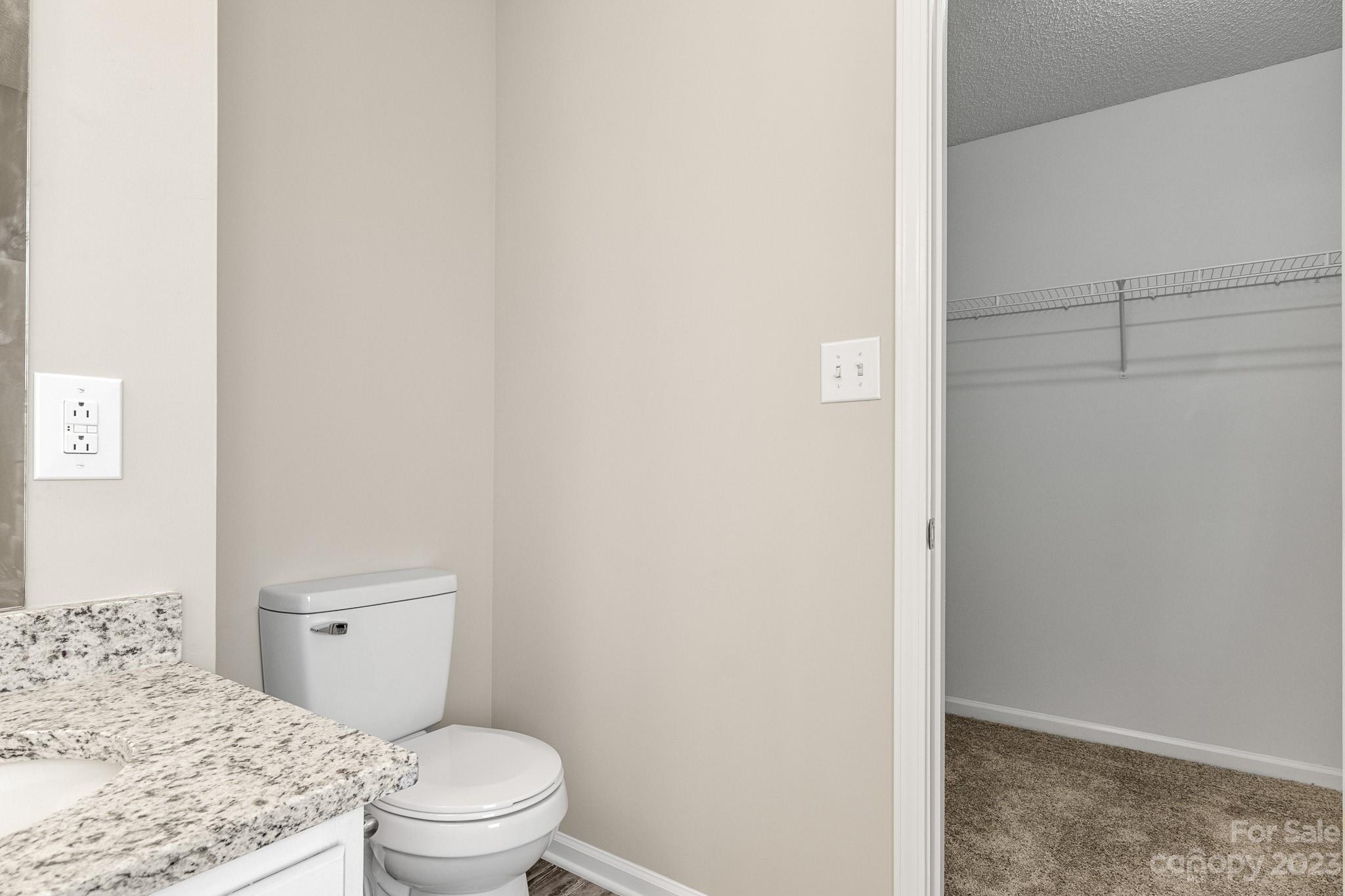 845 Raindrops Road Gastonia, NC 28054 - Photo 29 of 40 a bathroom with a granite countertop toilet and a sink