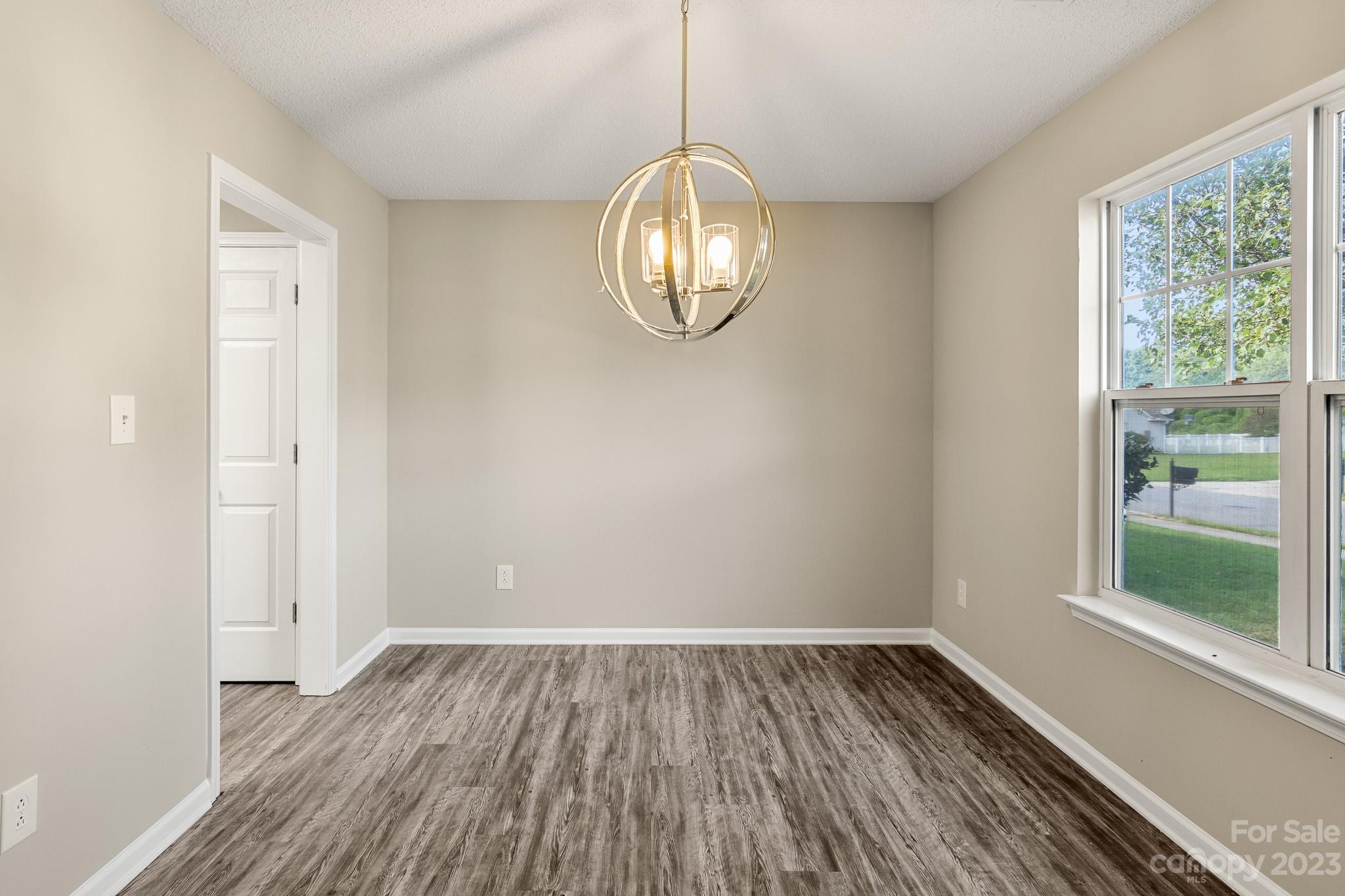 845 Raindrops Road Gastonia, NC 28054 - Photo 3 of 40 a room with wooden floor mirror and windows