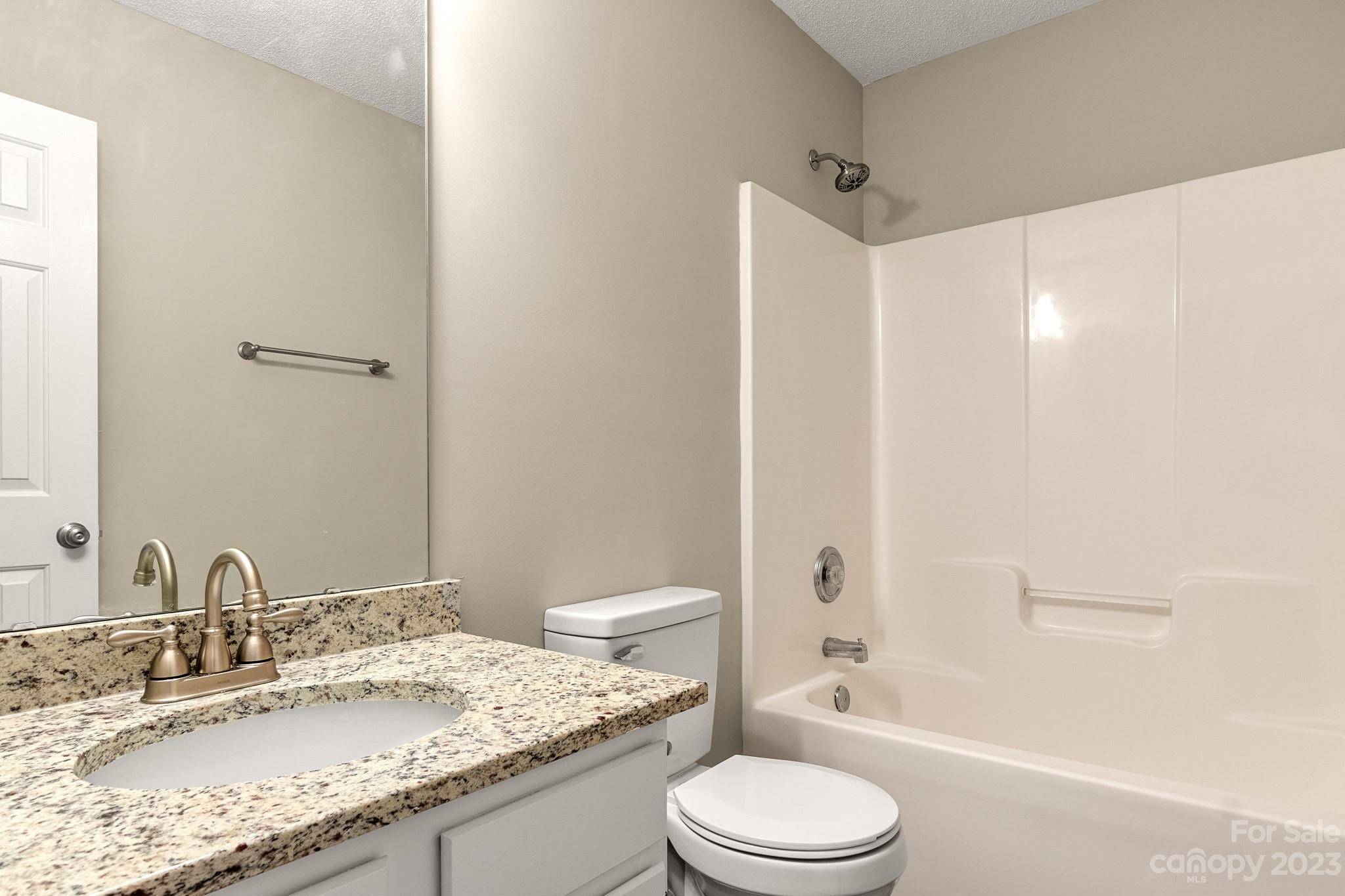 845 Raindrops Road Gastonia, NC 28054 - Photo 35 of 40 a bathroom with a granite countertop sink toilet and shower