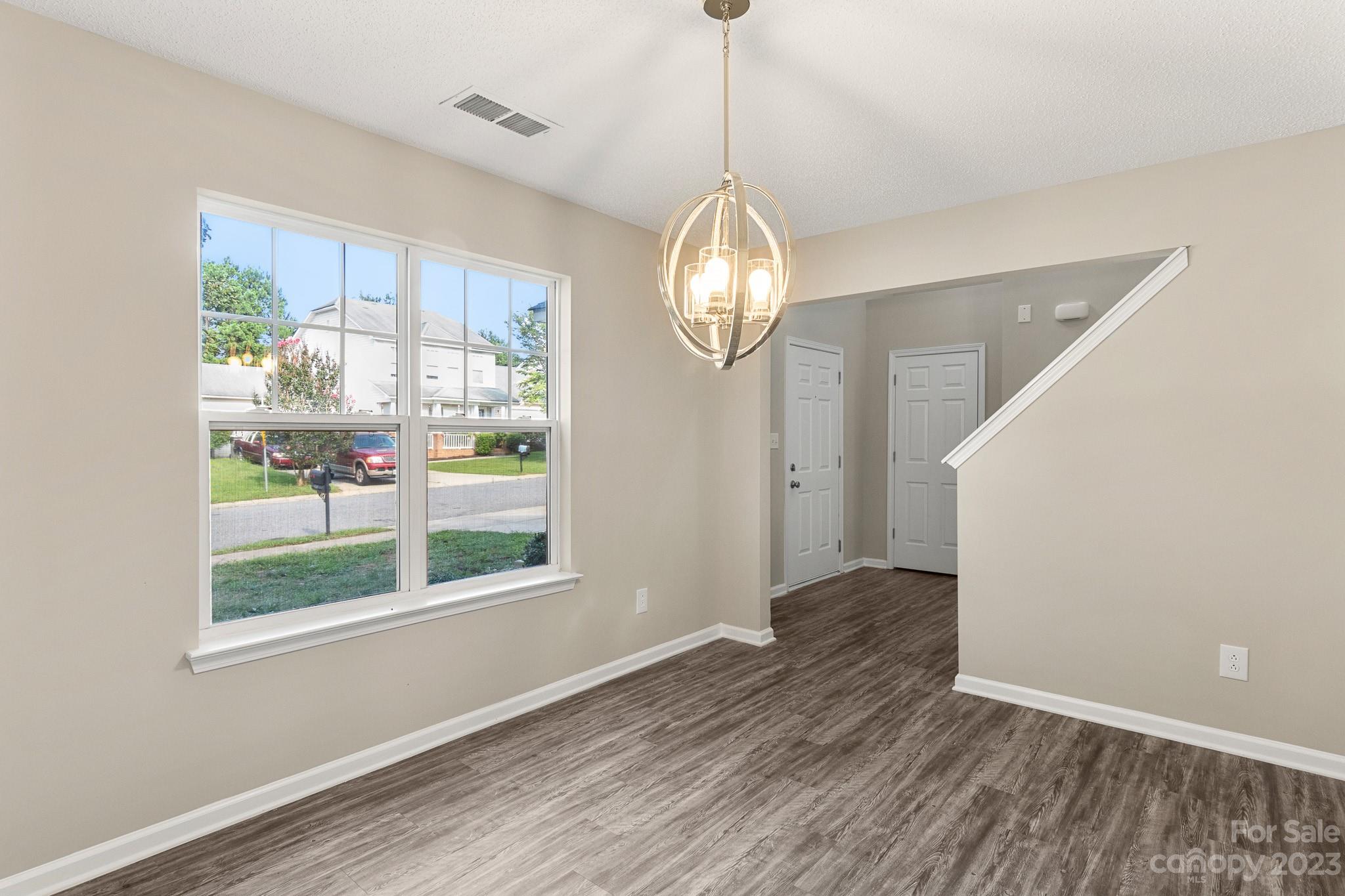 845 Raindrops Road Gastonia, NC 28054 - Photo 4 of 40 a view of a big room with wooden floor and windows
