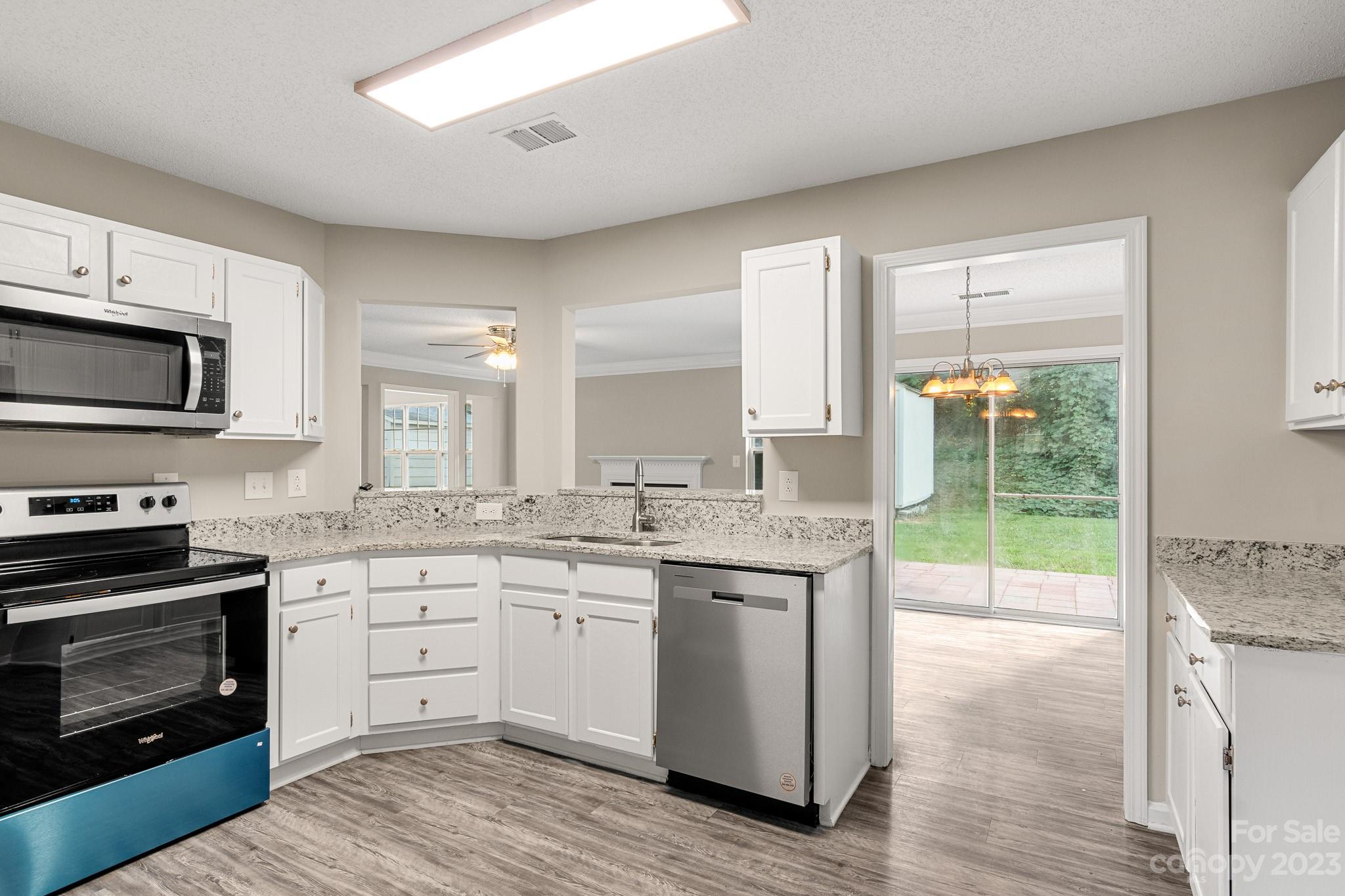 845 Raindrops Road Gastonia, NC 28054 - Photo 8 of 40 a kitchen with a sink stove and microwave