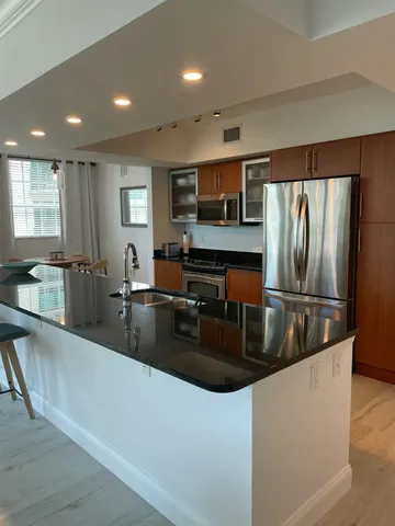 a kitchen with granite countertop a sink and a stove top oven