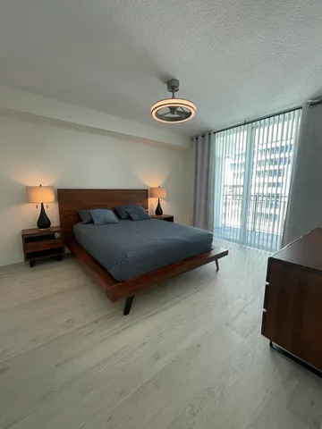 a bed sitting in a bedroom next to a window