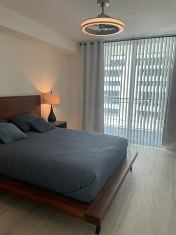 a spacious bathroom with a bathtub sink mirror and toilet