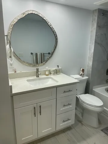 a bathroom with a toilet and a bath tub