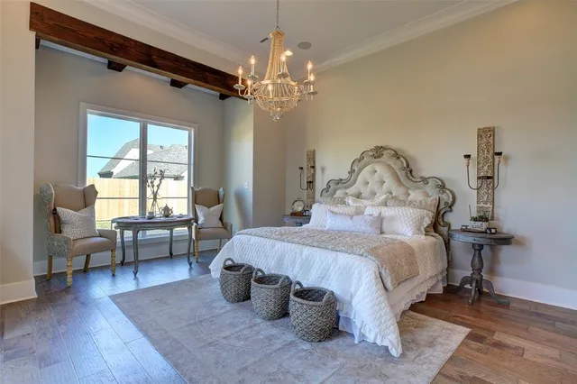 a bedroom with a bed and a chandelier