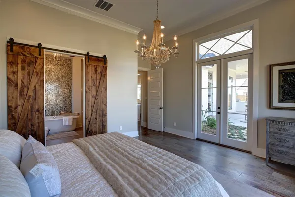 a bedroom with a bed and a chandelier