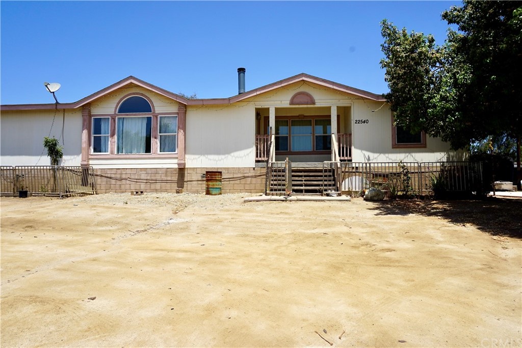 22540 Marquez Road Perris, CA 92570 - Photo 1 of 1 a front view of a house with a yard
