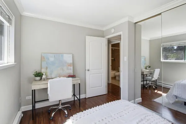 a bedroom with a bed and a table in it