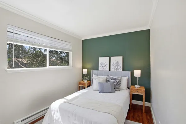 a bedroom with a bed and window