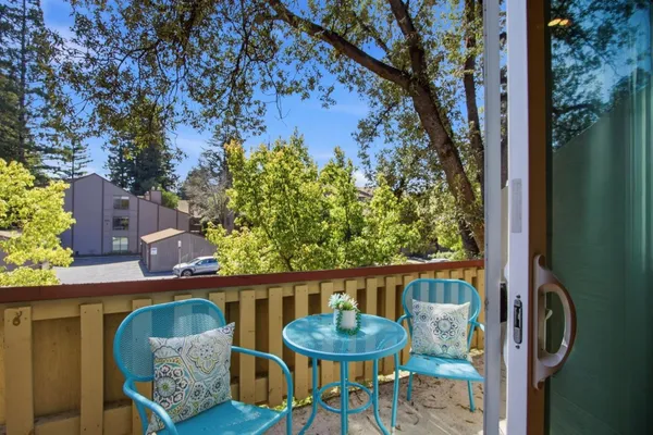 a balcony with furniture and a potted plant